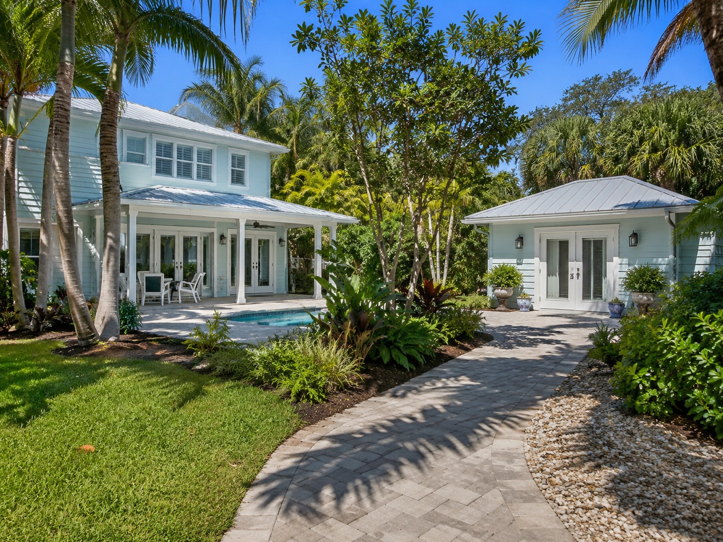 Modern residential backyard with tropical landscaping and outdoor living area