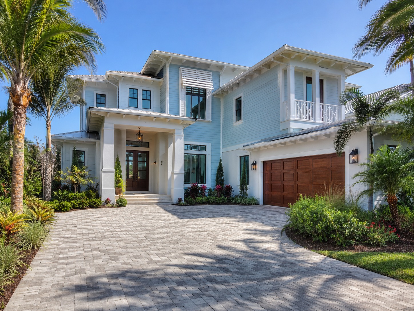 Modern tropical suburban home exterior with garage and palm trees